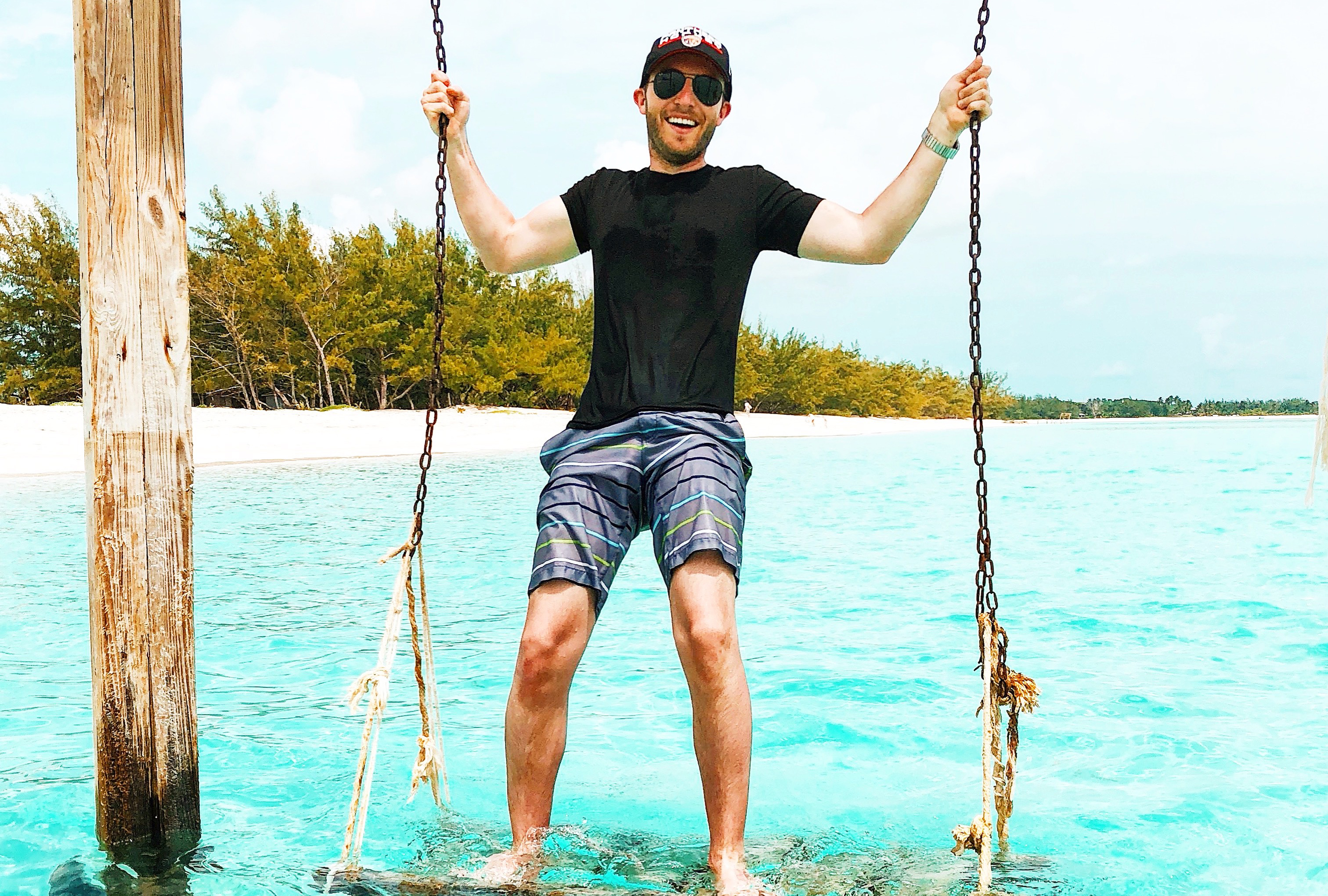 Nicolo Bates poses on a swing over the ocean