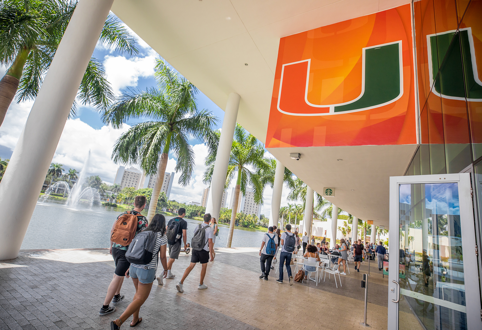Students walking through a University of Miami campus building.