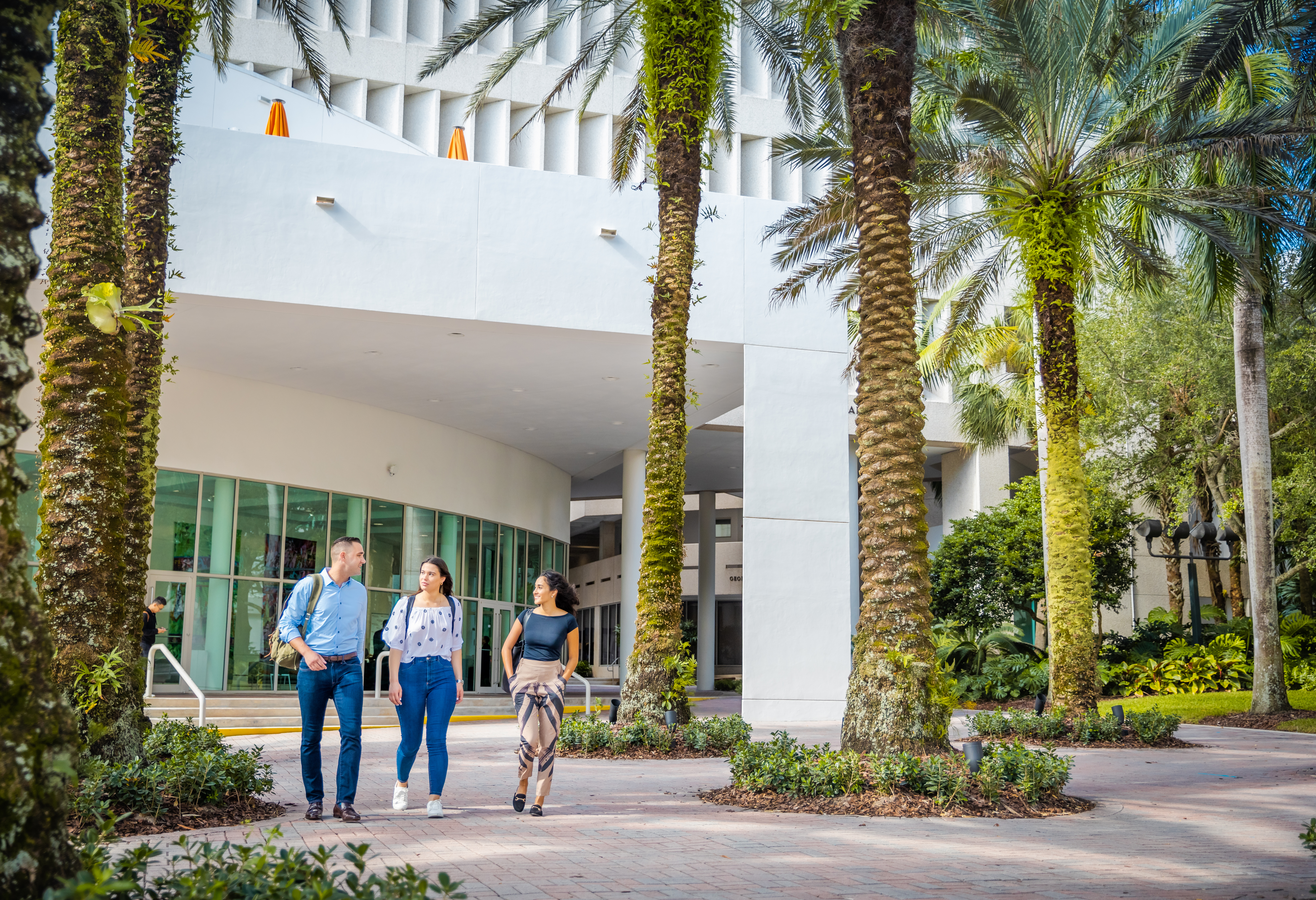 Students walking by the Miami Herbert Business School building.