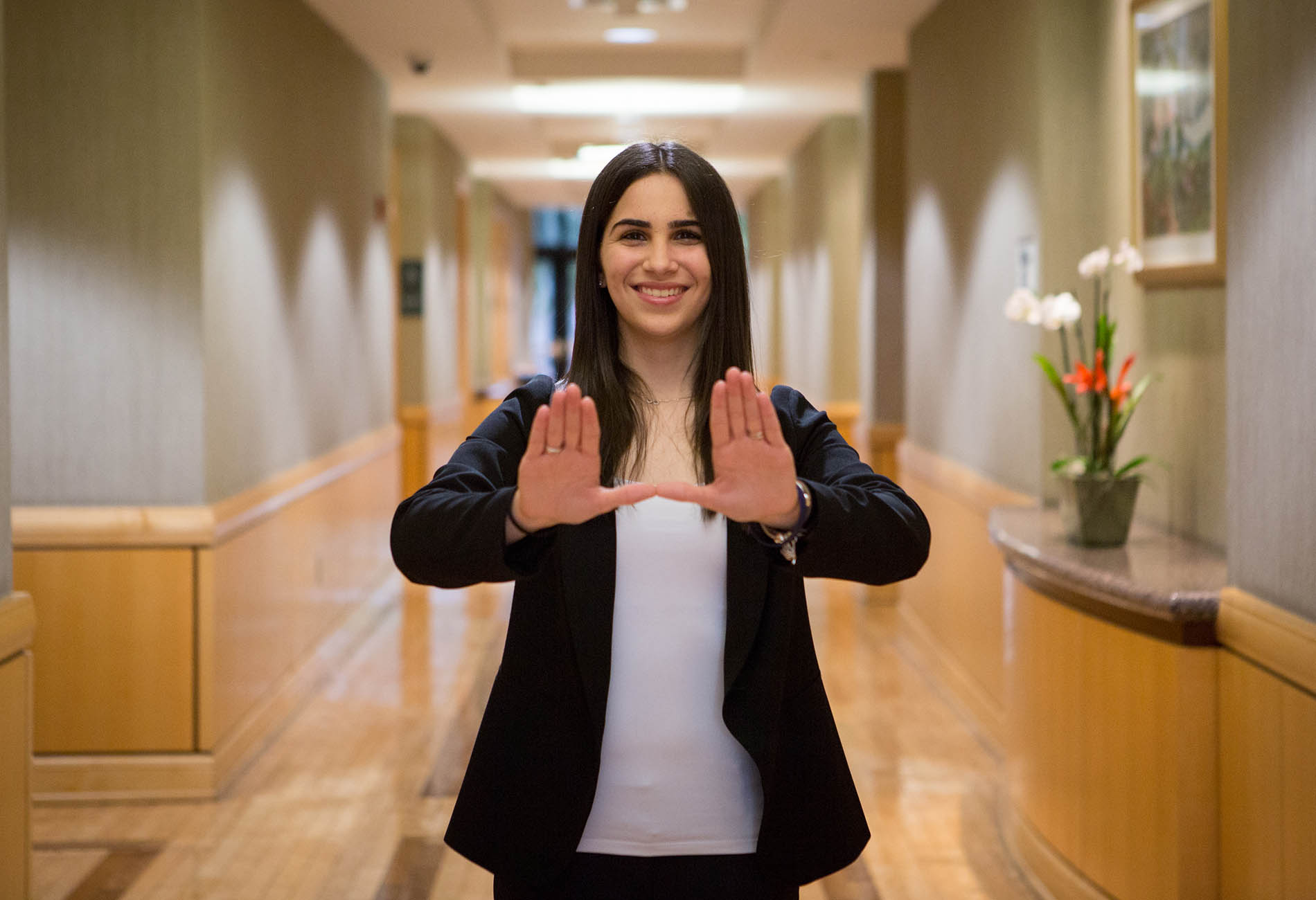 female student holding up the U sign with her hands