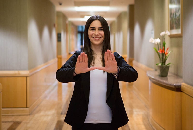 female student holding up the U sign with her hands