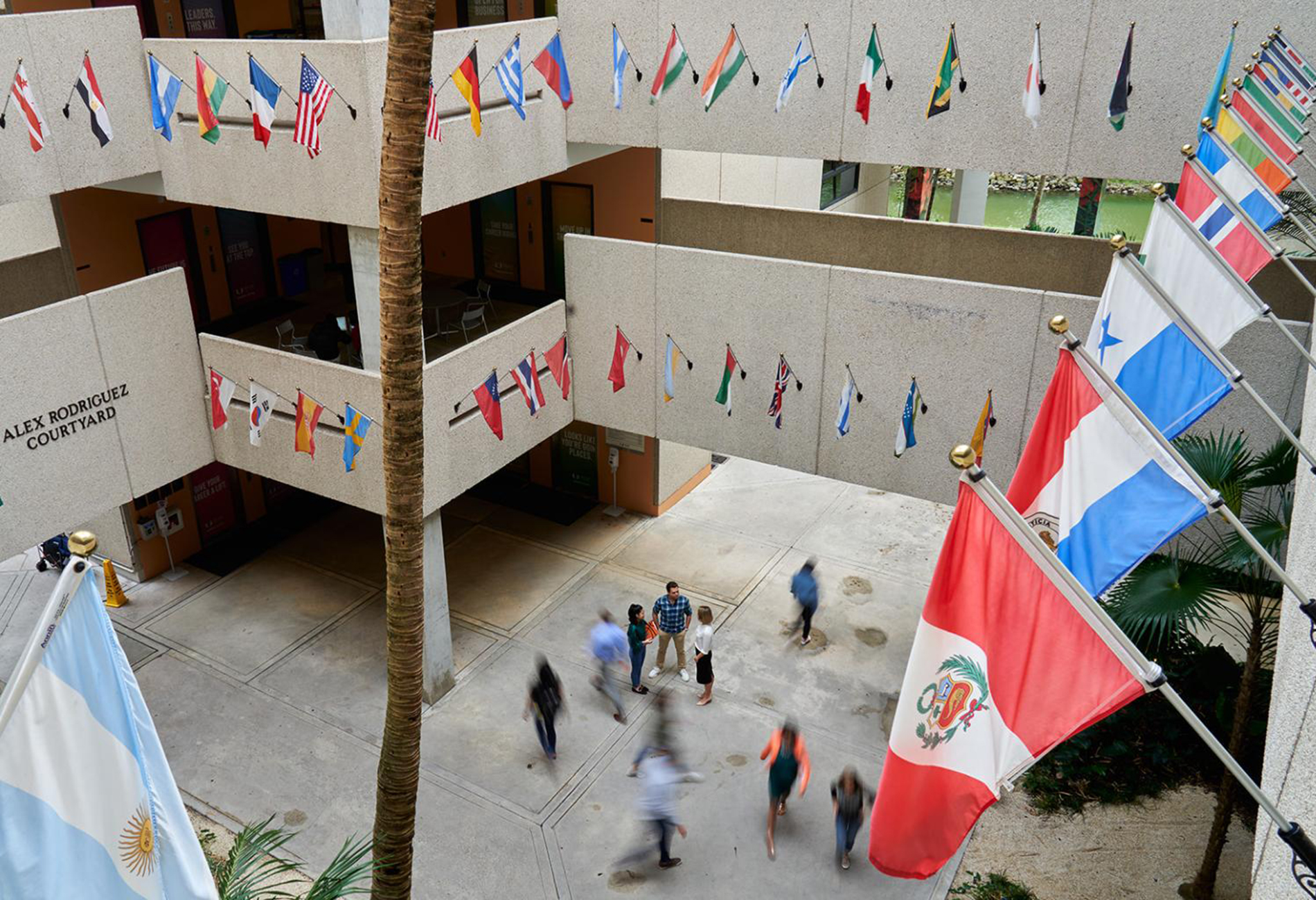 Bird's eye view from the second floor of Miami Herbert Business School Building showing the flags of different countries.